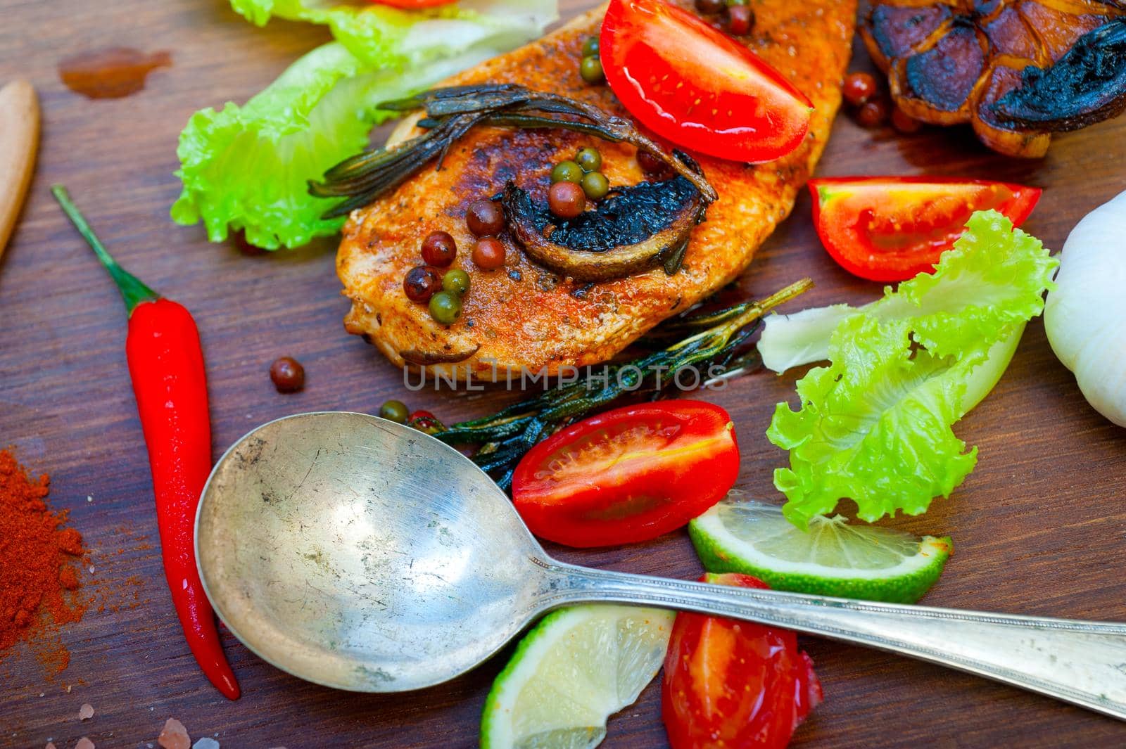 wood fired hoven cooked chicken breast on wood board  by keko64