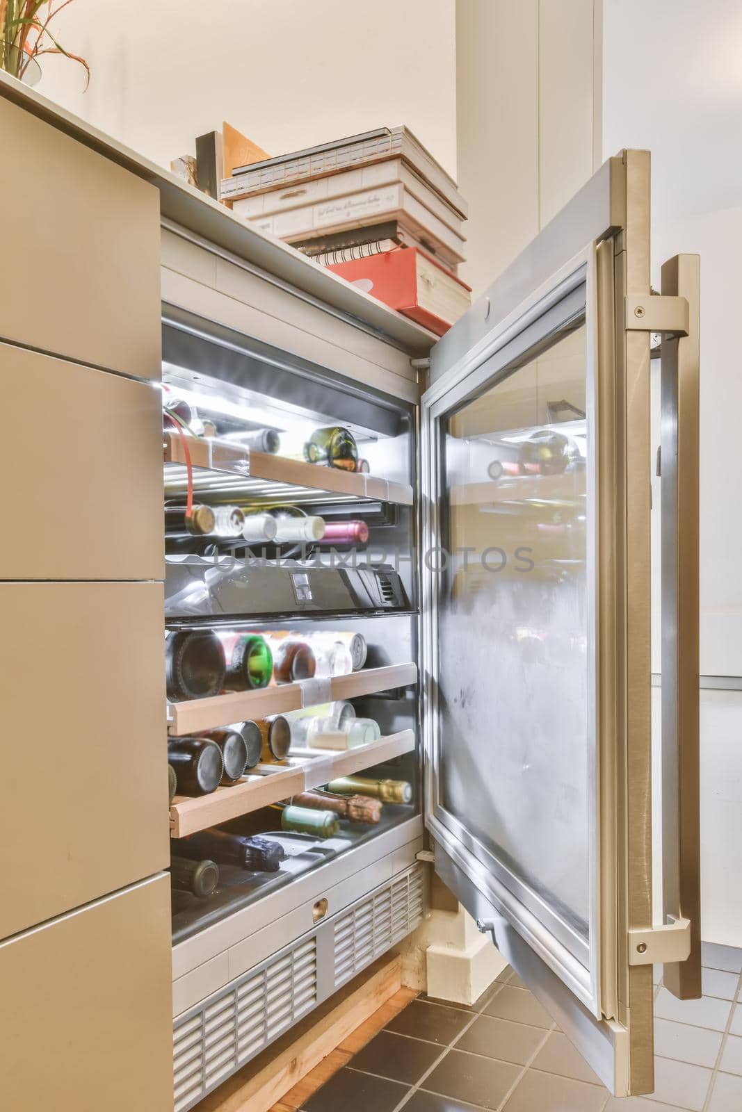 Open door of a bottle cooler by casamedia