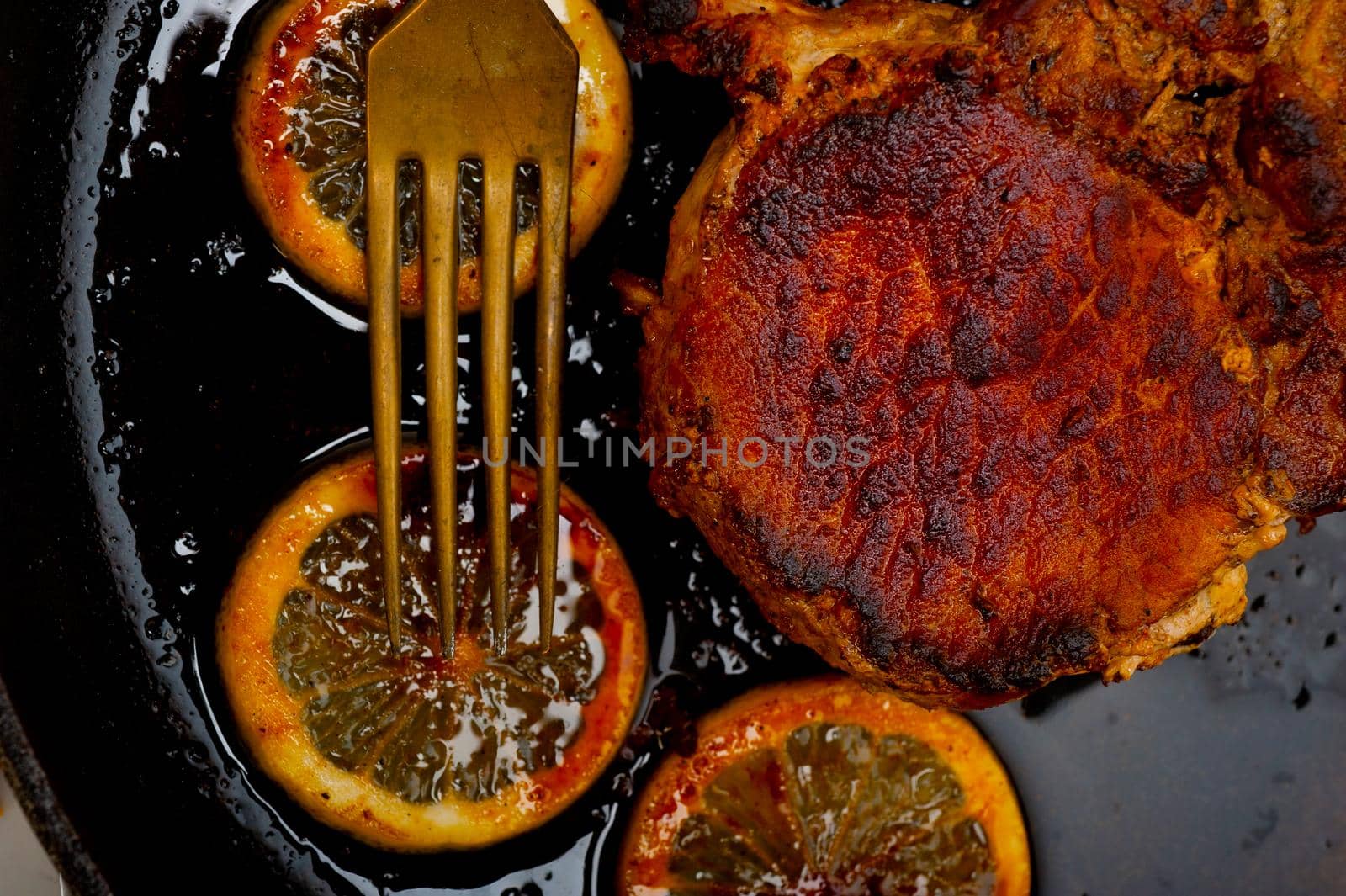 pork chop seared on iron skillet by keko64