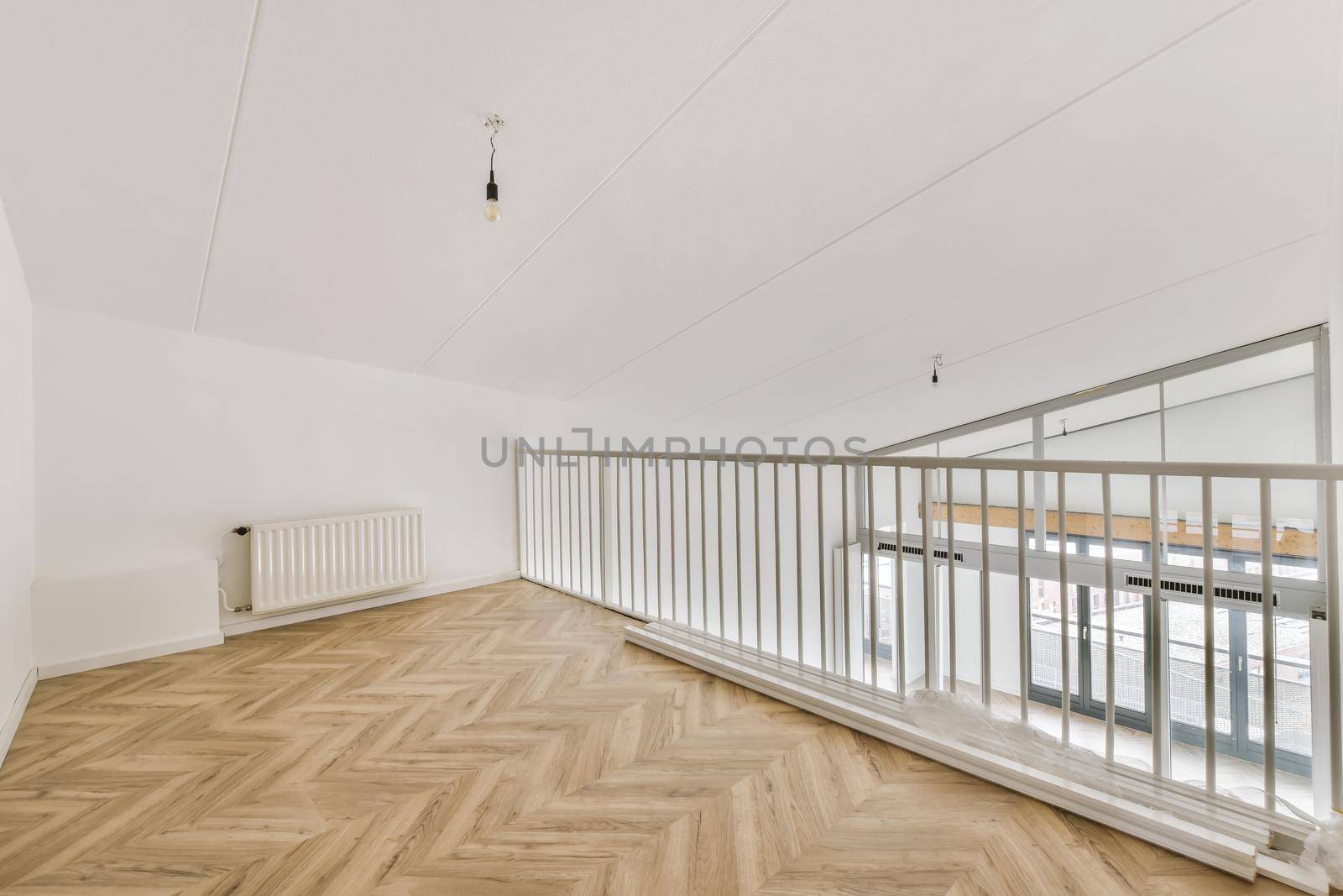 Interesting design of the balcony inside the house with parquet