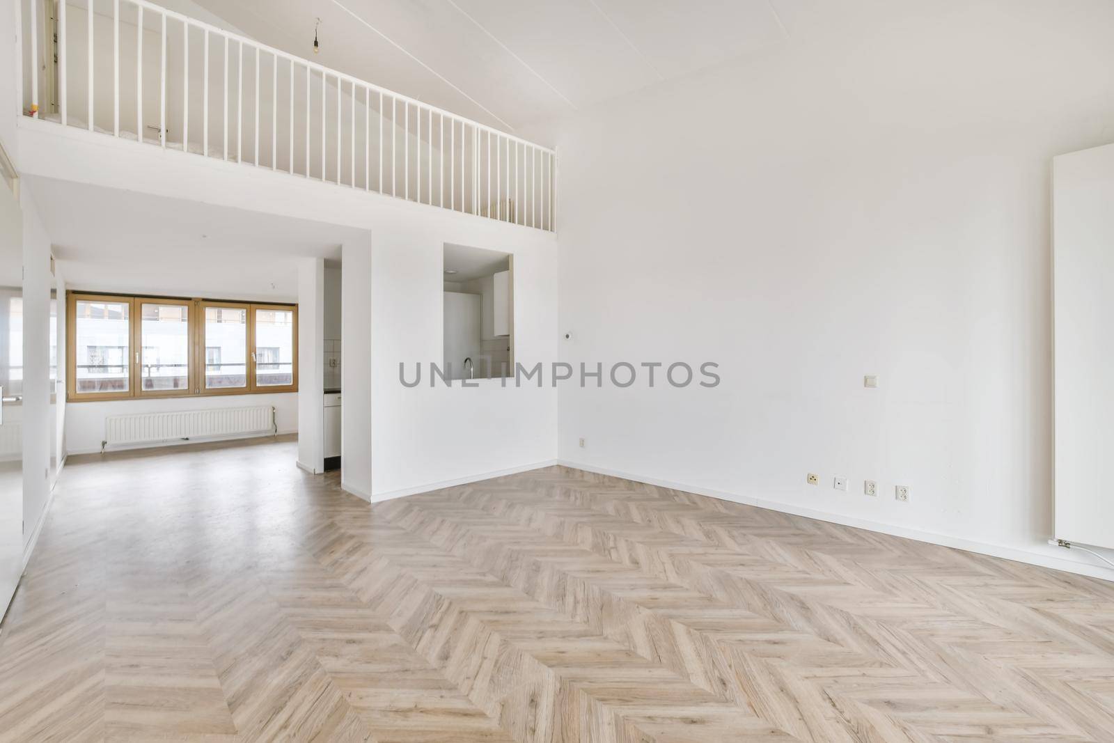 Luxurious room with a second floor upstairs with a railing
