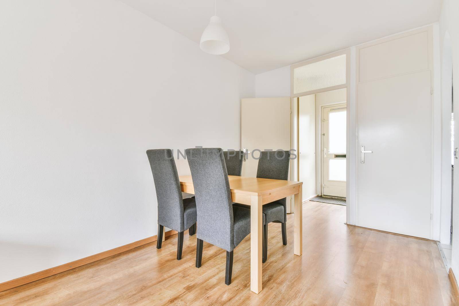 Spacious dining room table and chairs in modern apartment in minimal style