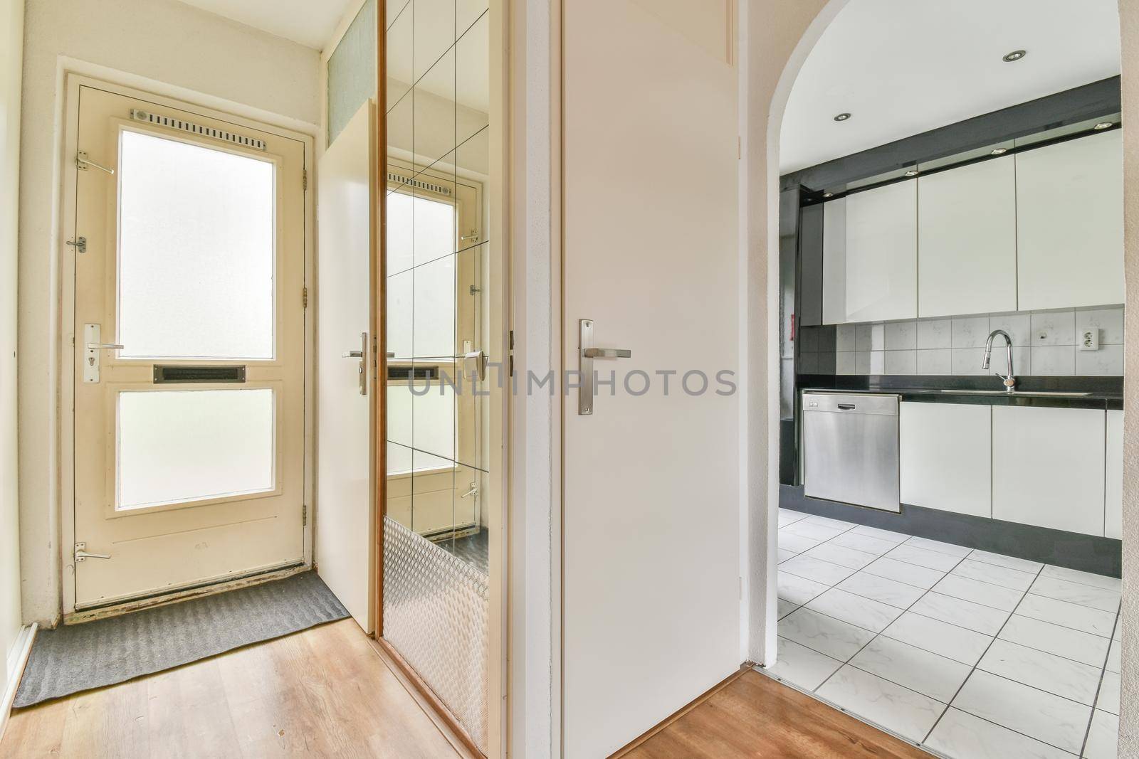 Interior of the light kitchen with modern appliances in a modern flat at daytime