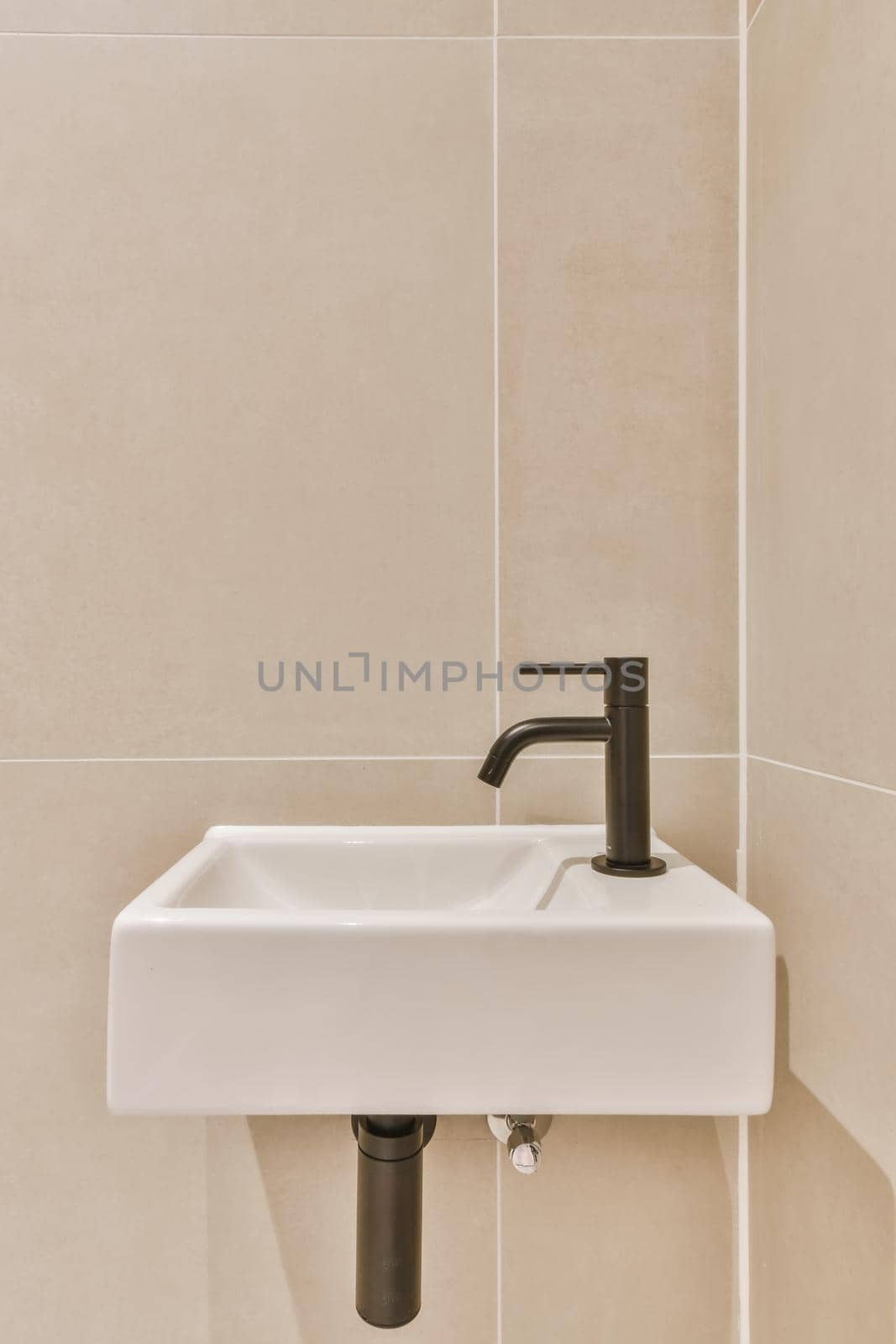 Stylish bathroom in a minimalist style with a small sink by casamedia