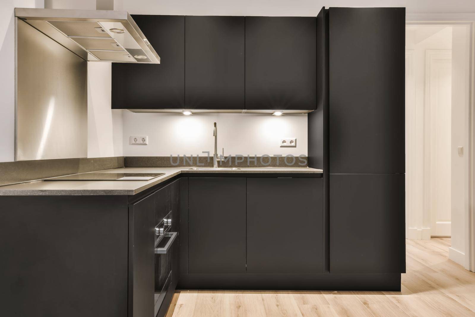 Modern kitchen with black kitchen unit and parquet floor