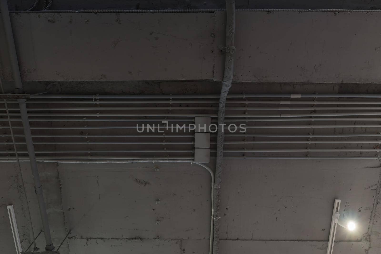 Interior architecture and ceiling design of industrial loft building decorated with modern lamps, glass windows and wall speakers