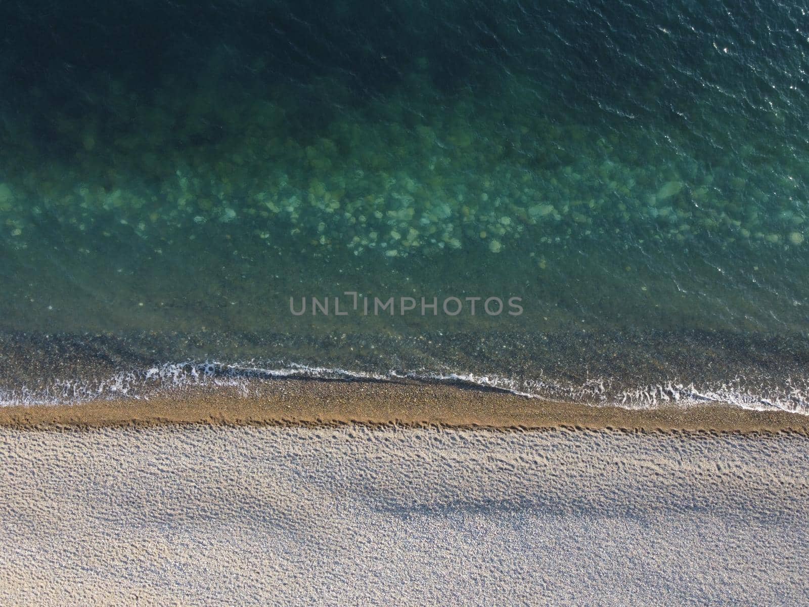 Aerial panoramic view of beautiful sunset above sea. Beautiful seascape. Sun glare, small waves on the water surface. Evening. Horizon. Nobody. No people. Copy space. Never-ending beauty of nature