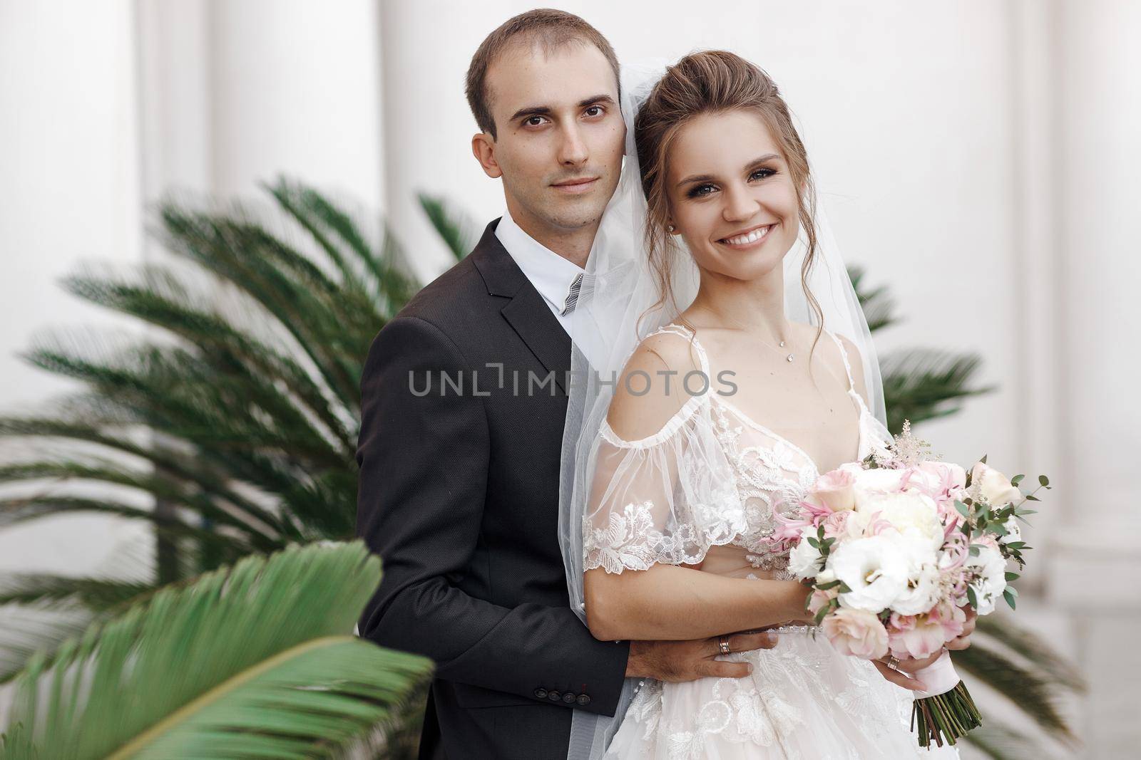 Wedding portrait of a smiling bride and groom. High quality photo