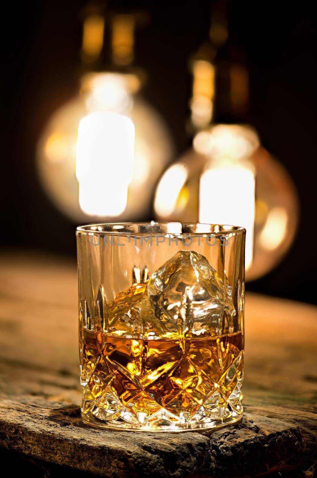 Glass of whiskey lighting with edison lamps