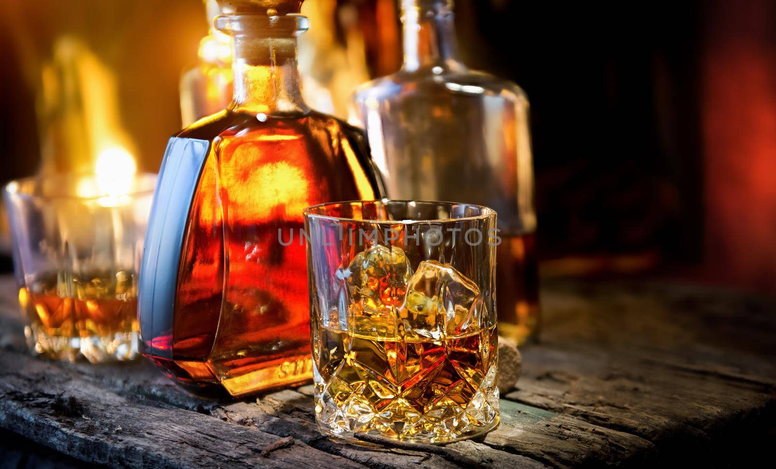 Glass and bottle of whiskey on a wooden table