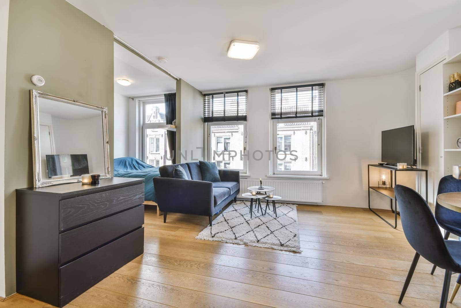 Delightful living room with black comfortable sofa with round coffee table