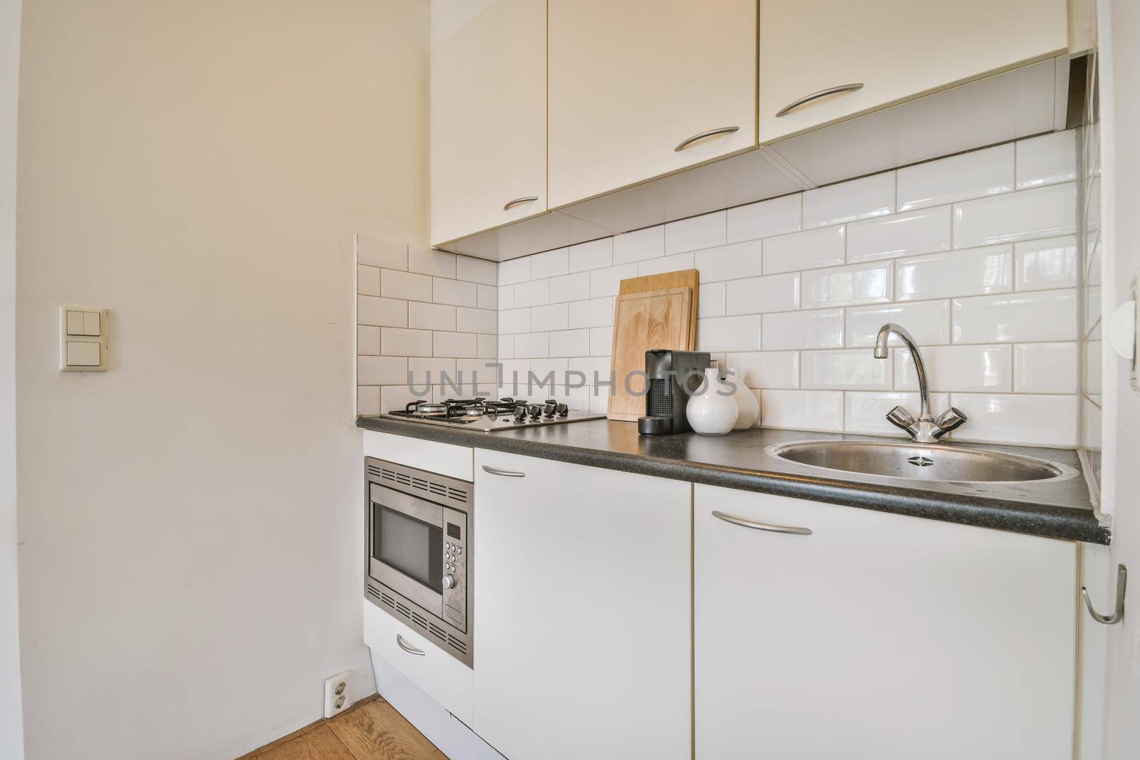 Delightful small kitchen area with microwave built into the kitchen unit