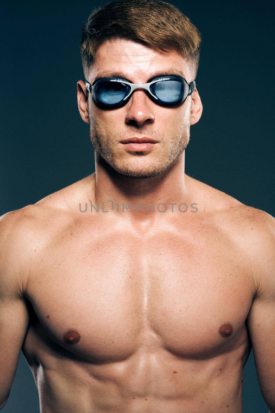 sports man with naked torso swimmer professional dark background by Vichizh