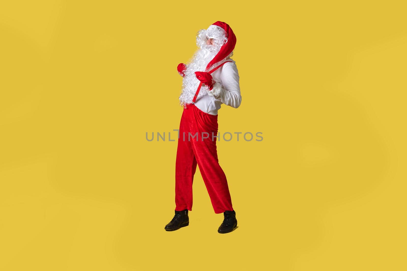 Santa claus yellow funky fast man new, fun eve bearded caucasian, smile in suspenders with a large beard by 89167702191
