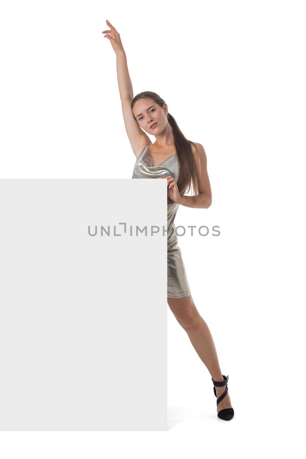Young party girl in silver dress displaying blank banner isolated over white background