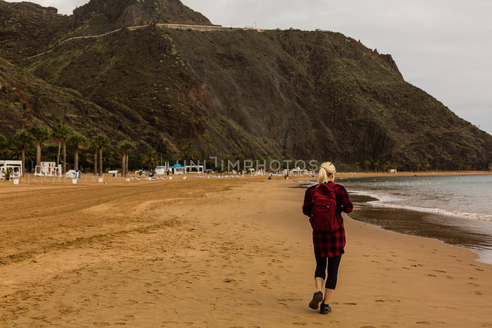 Tenerife. Woman traveler tourist looking at beach view. Playa de las Teresitas, Tenerife, Canary Islands, Spain