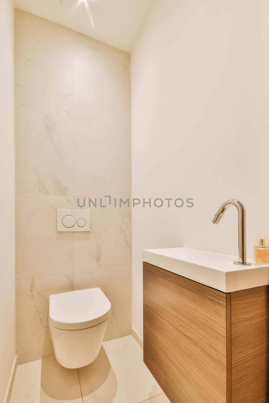 Luxurious restroom with a beautiful hanging wooden chest of drawers with a sink