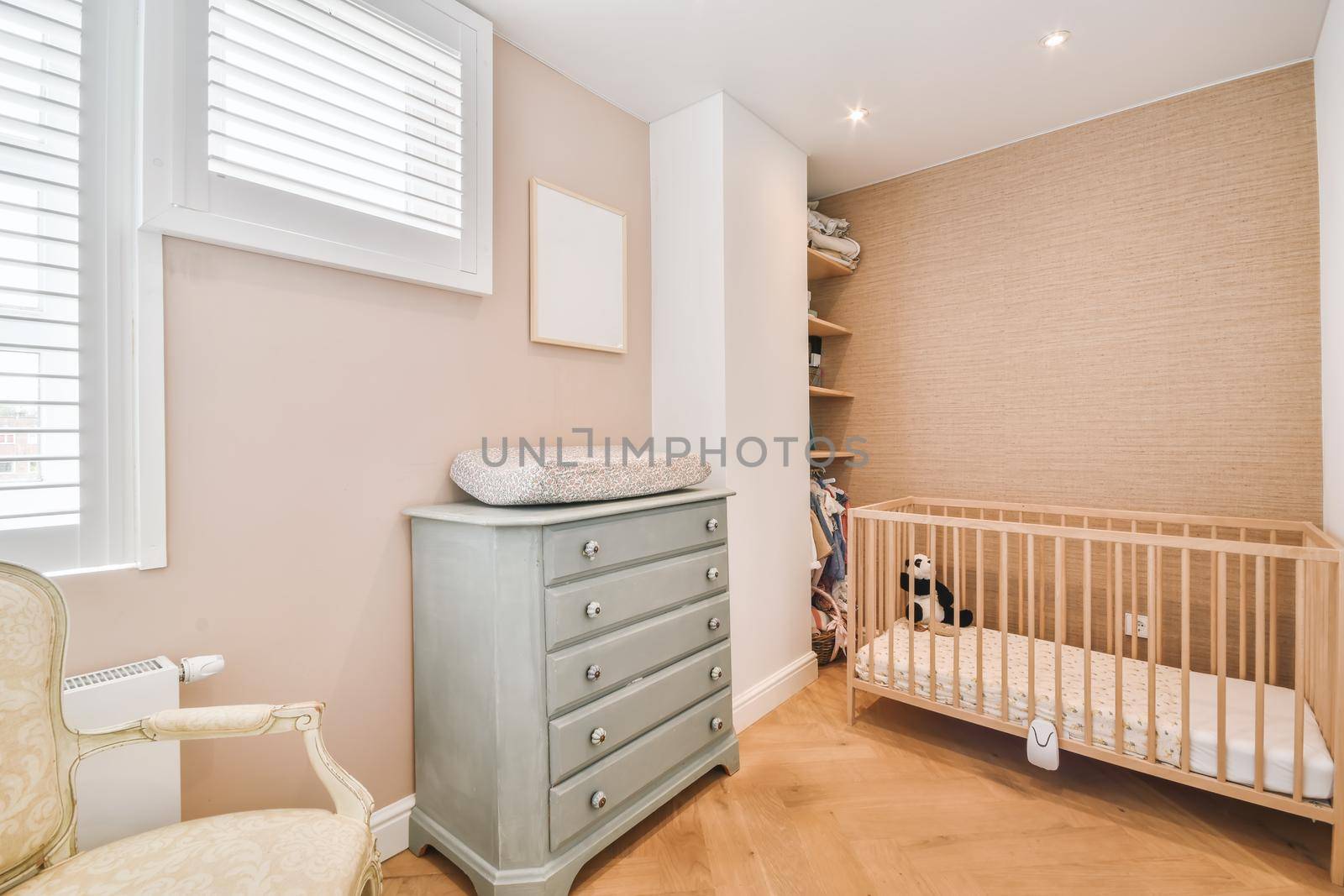 Cozy children's room in the daylight with a small crib
