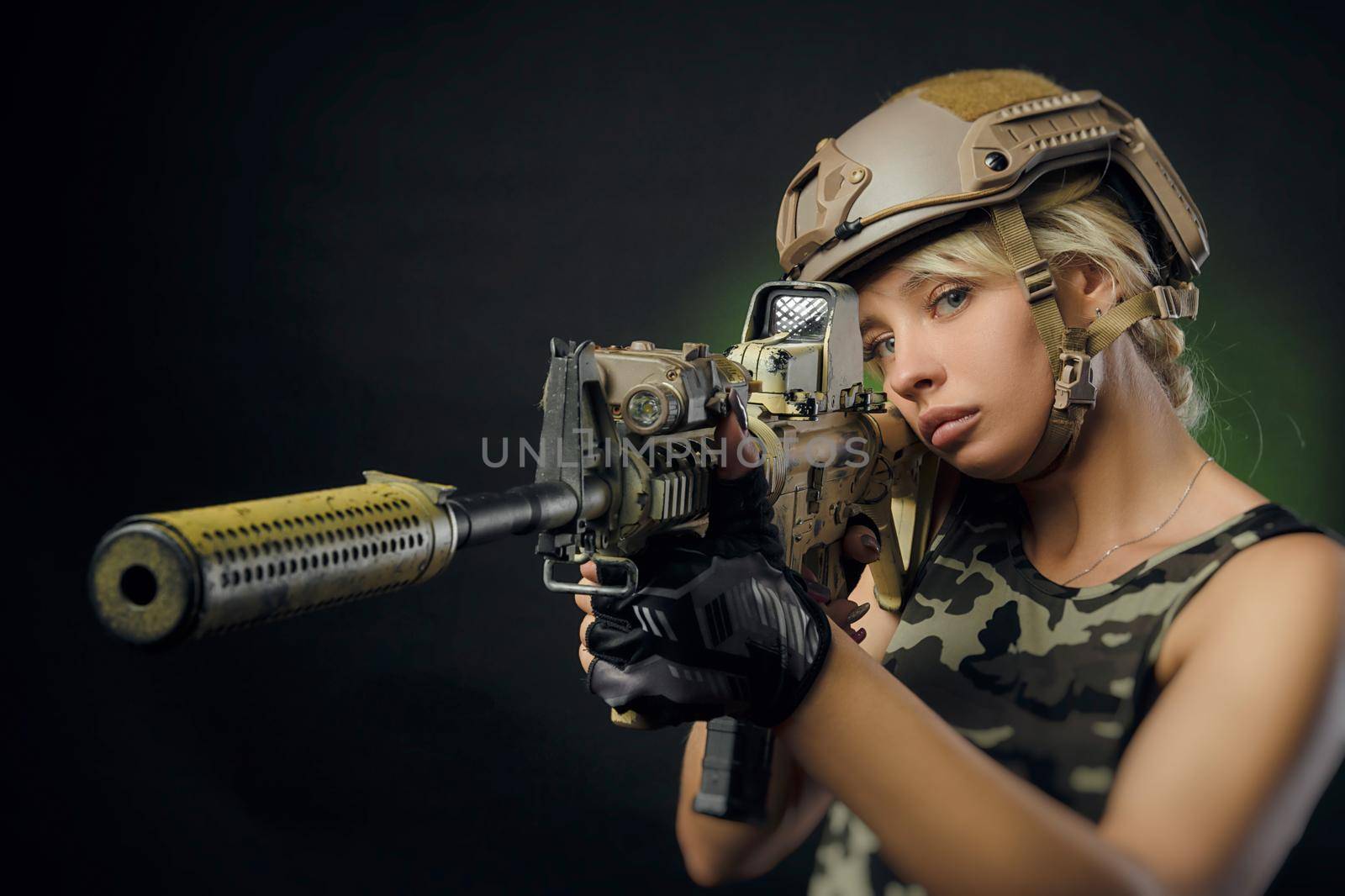 a soldier girl poses with an automatic rifle by Rotozey