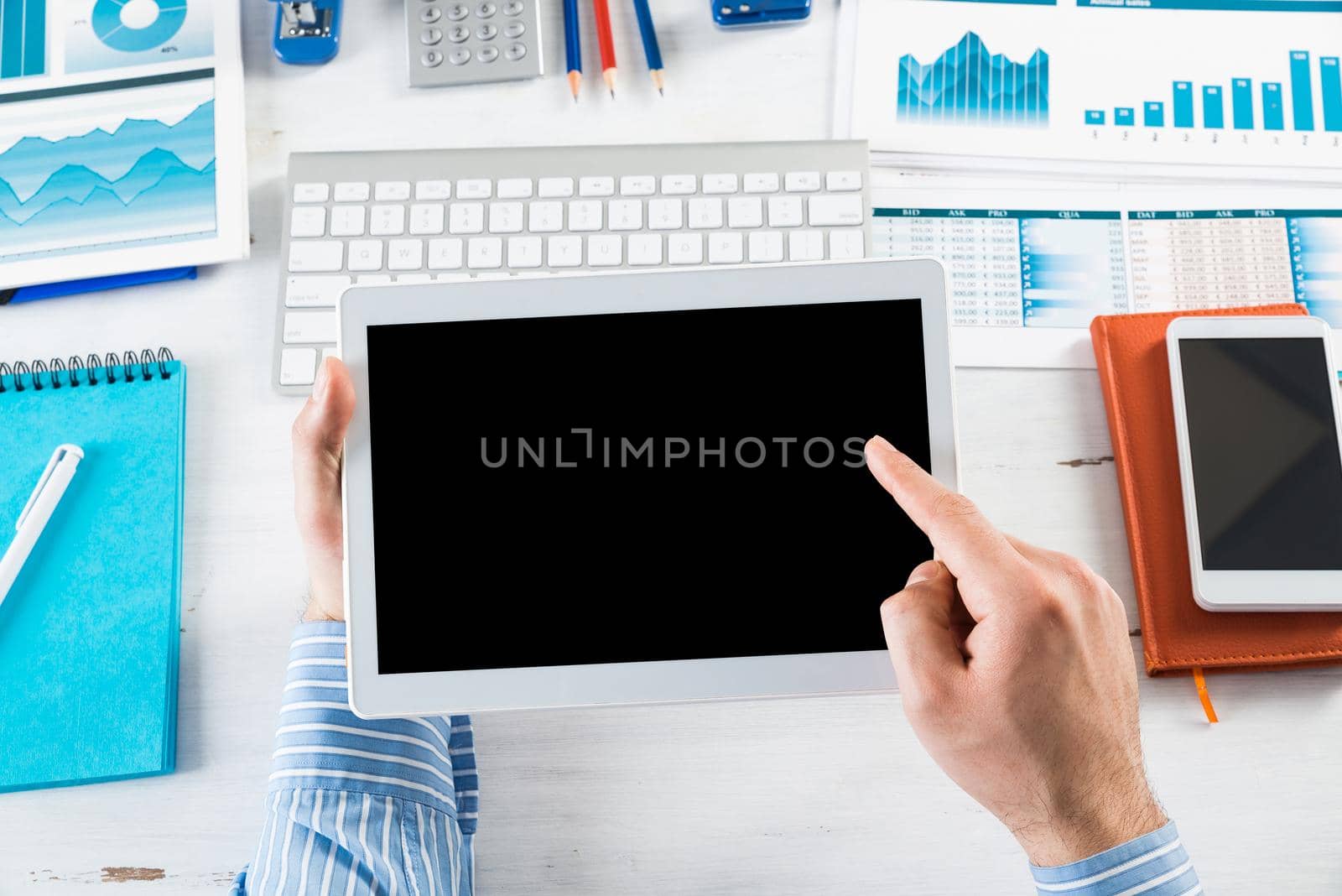 close-up of men's hands with a computer tablet. Businessman works in the office