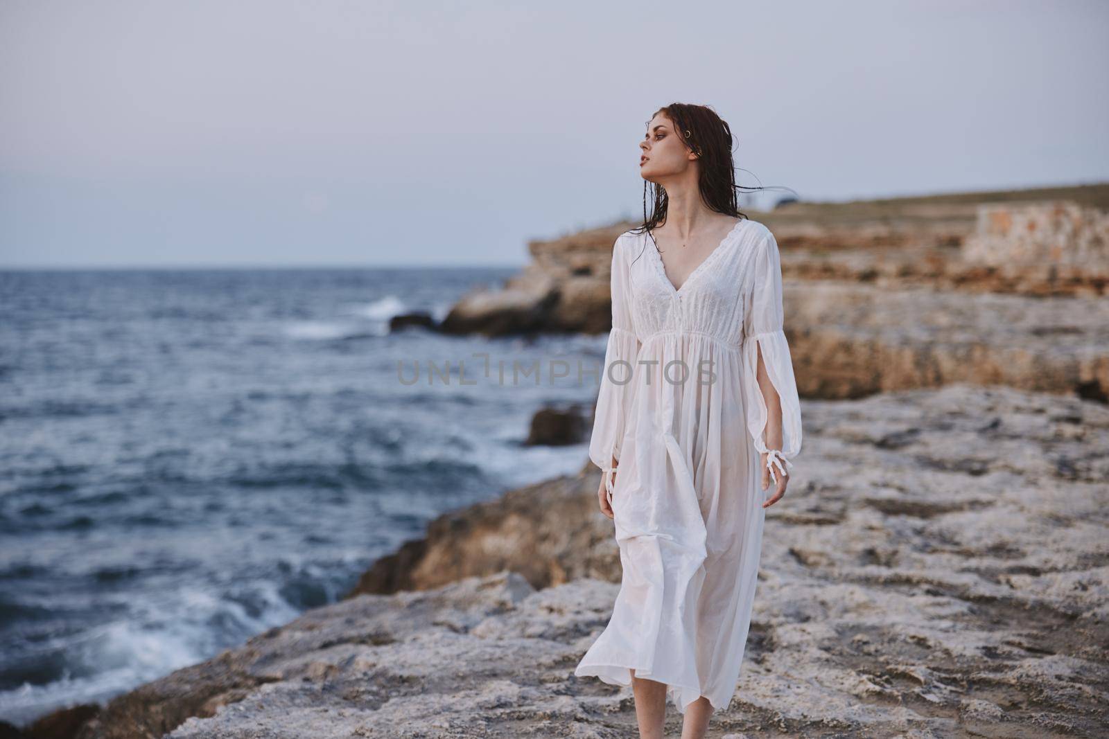 Beautiful woman white dress standing outdoor freedom unaltered. High quality photo