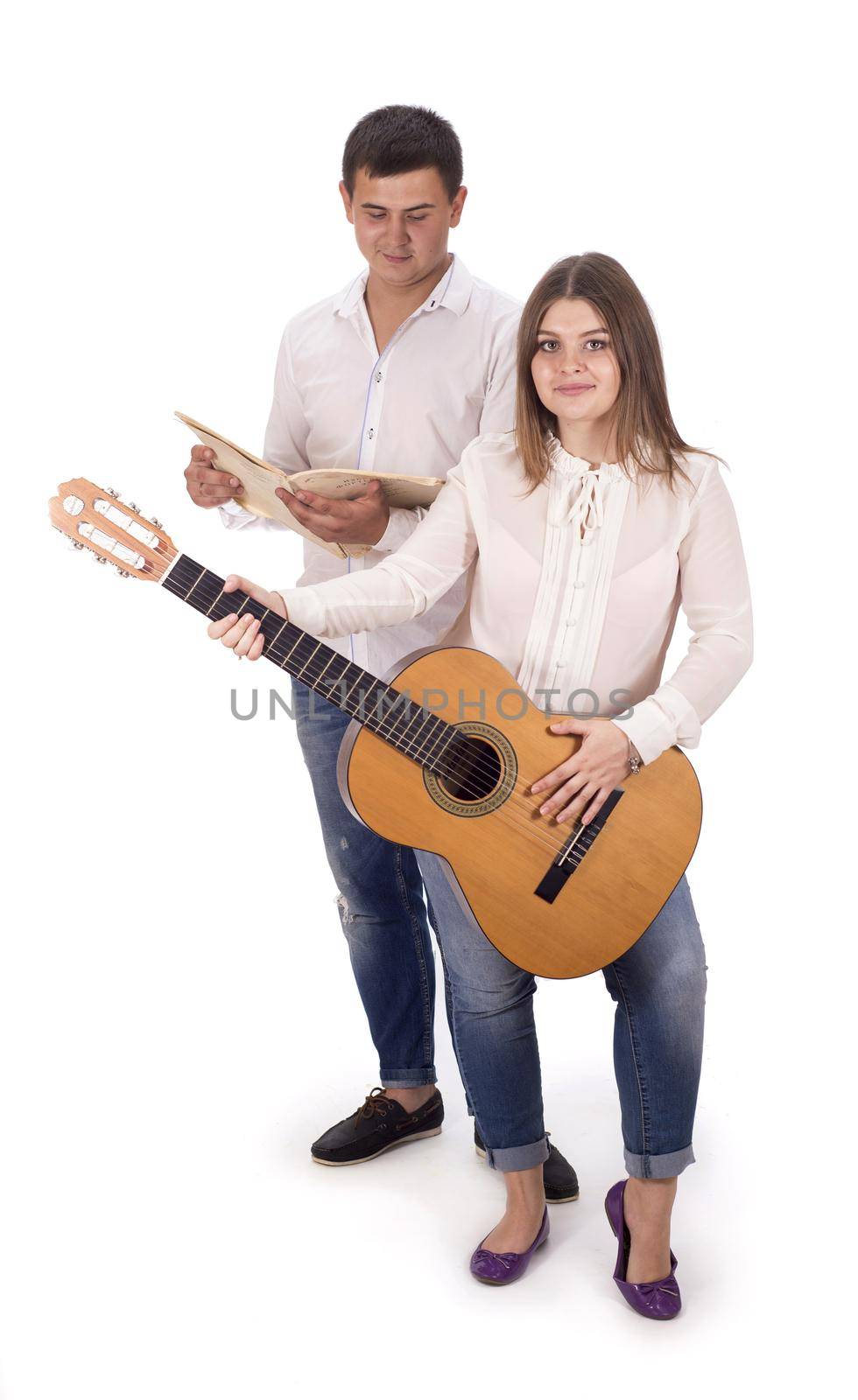 people and music. Pregnant woman and man in white shirts and jeans with guitar on white background by aprilphoto