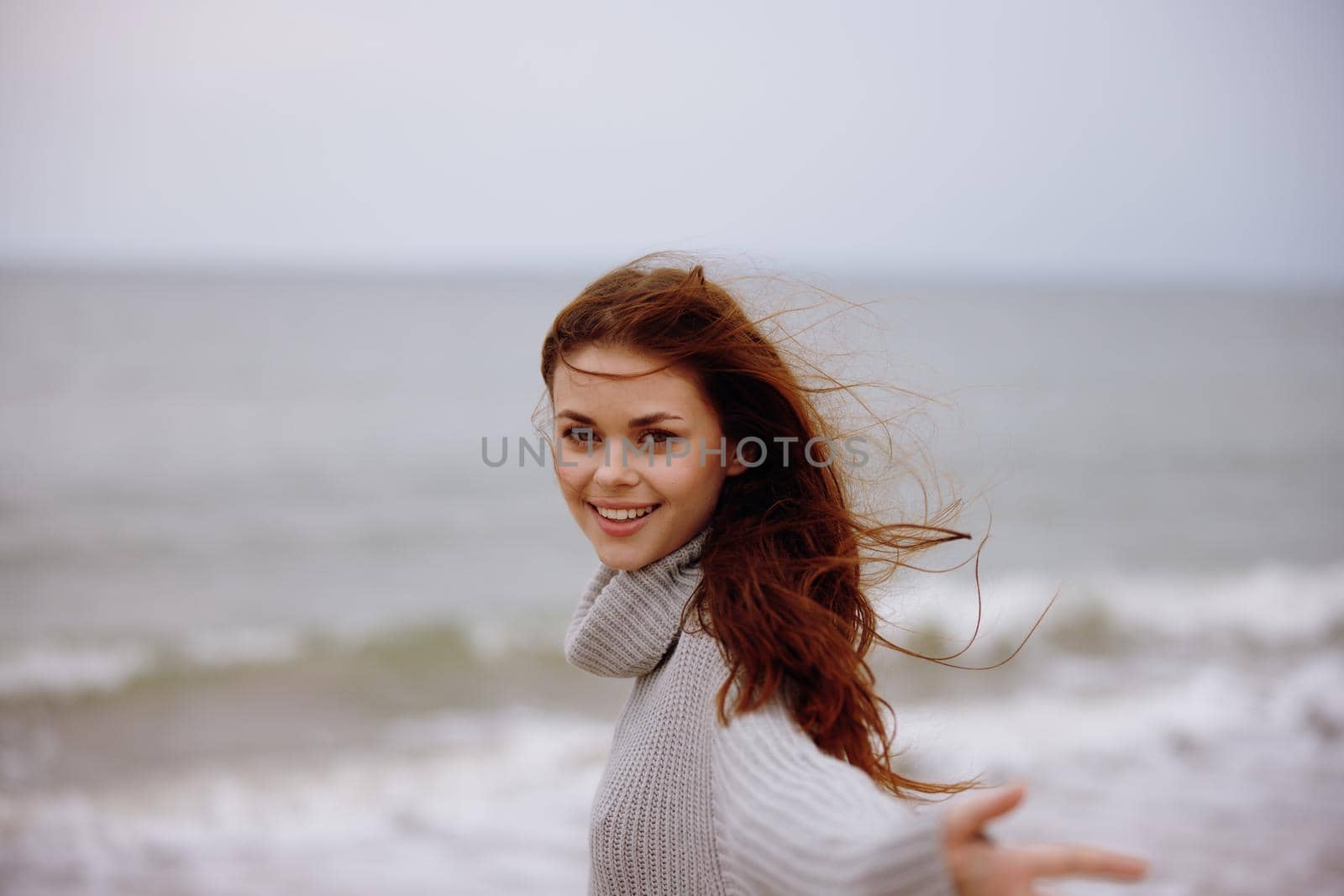 pretty woman with long hair on the beach nature landscape walk Relaxation concept. High quality photo