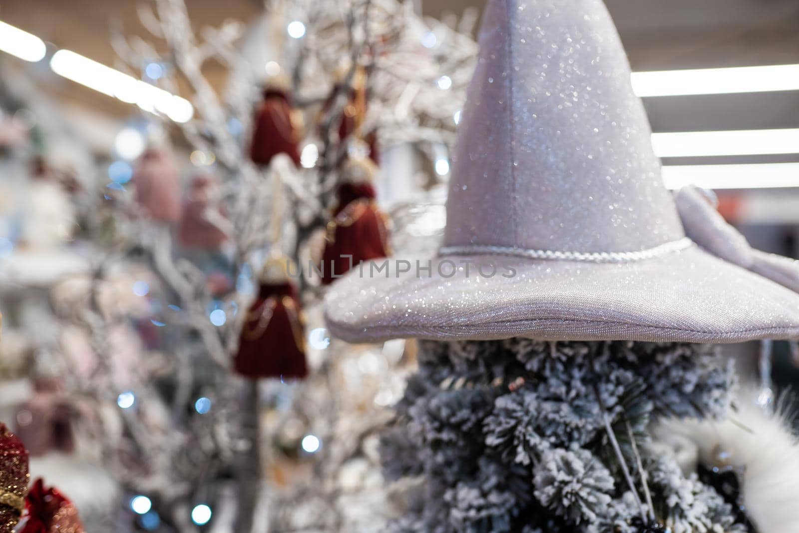 Close up of different object toy gifts hanging from a decorated Christmas tree.