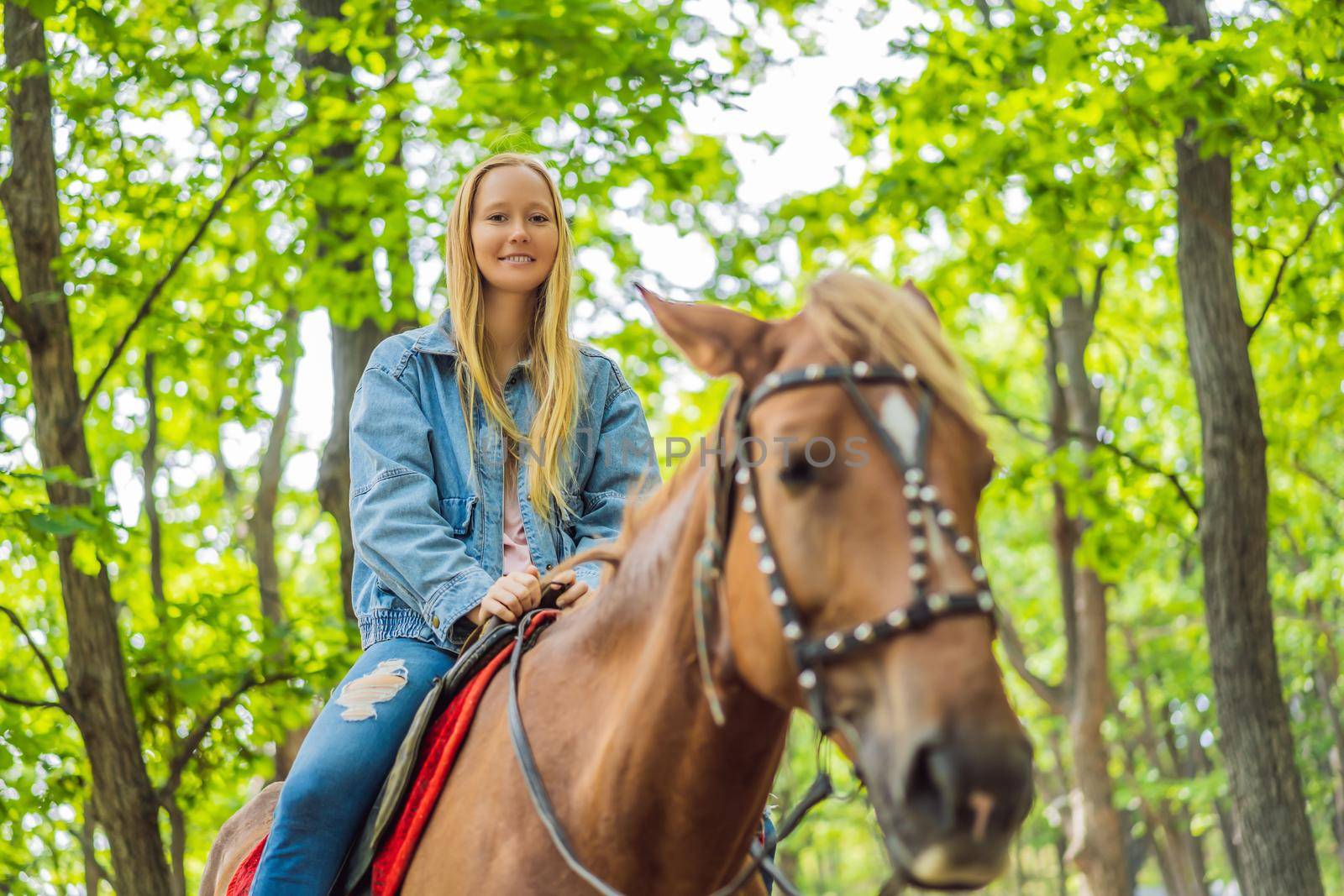 Beautiful woman riding a horse in countryside by galitskaya