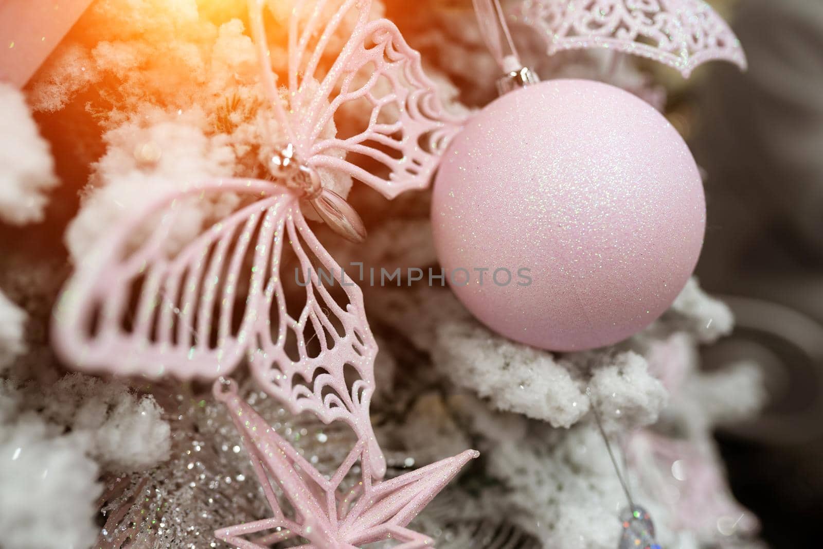 Close up of different object toy gifts hanging on a decorated Christmas tree.