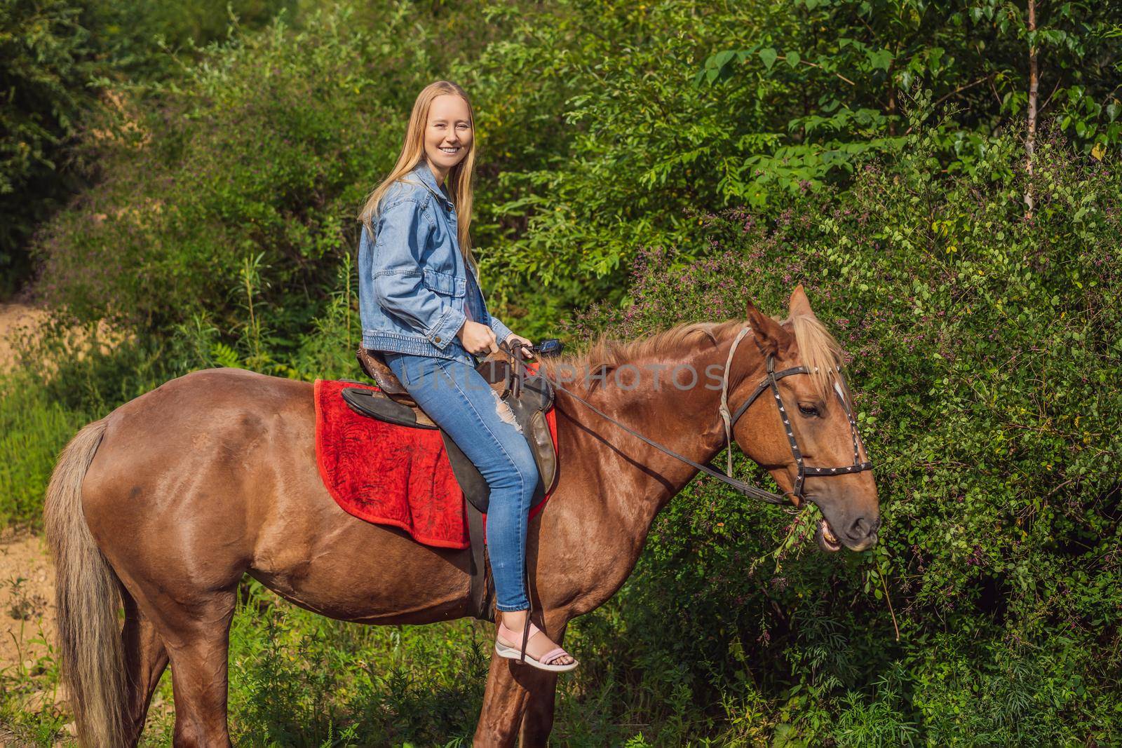 Beautifulwoman riding a horse in countryside.