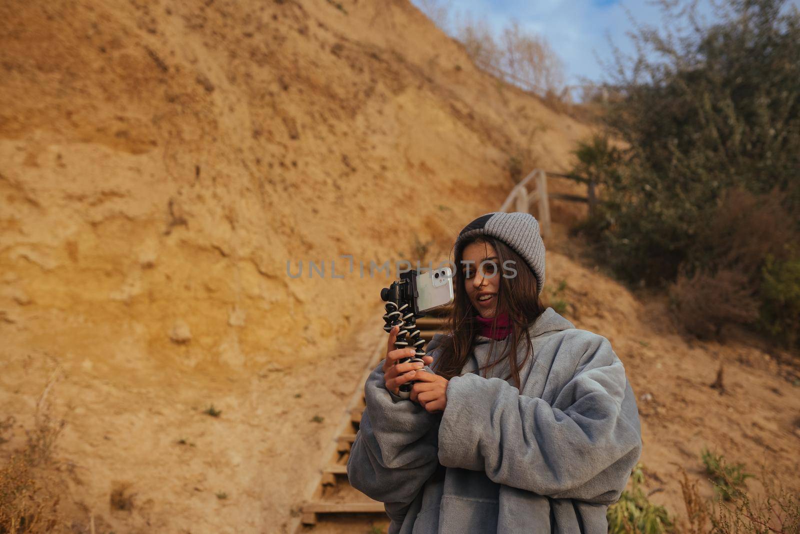 Woman takes a photo on a smartphone of the seascape