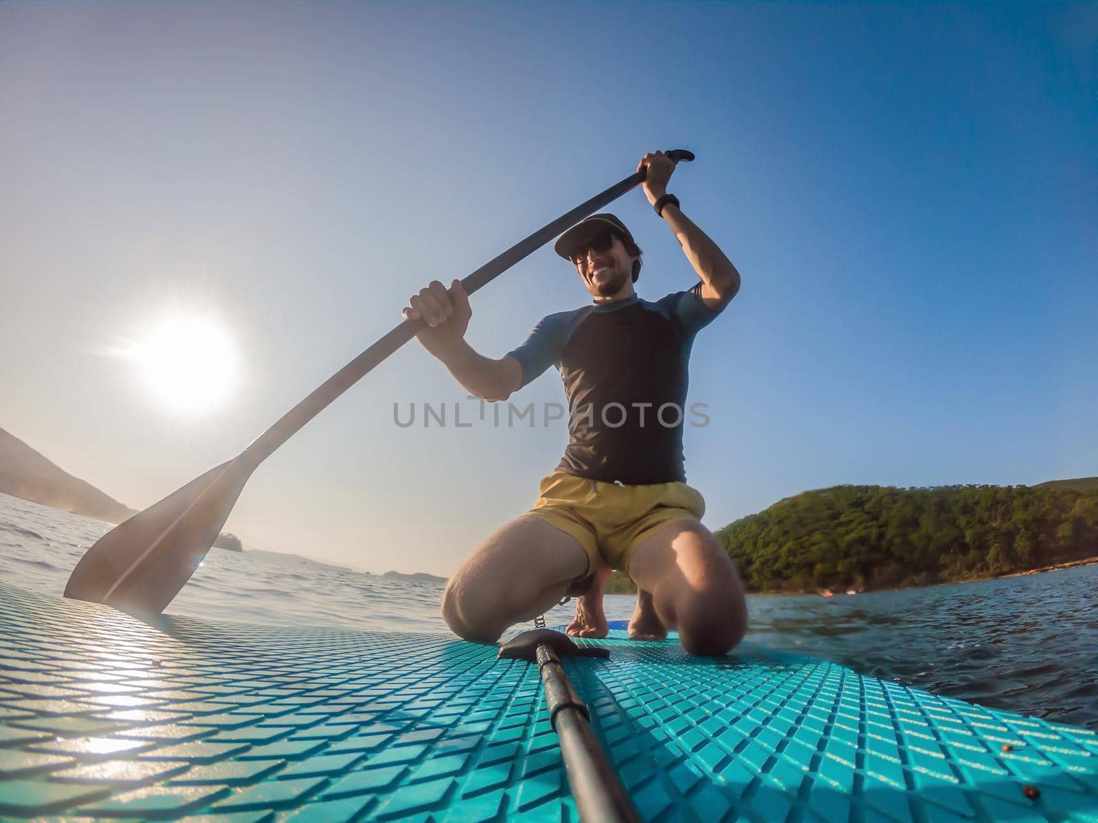 Attractive Man on Stand Up Paddle Board, SUP.