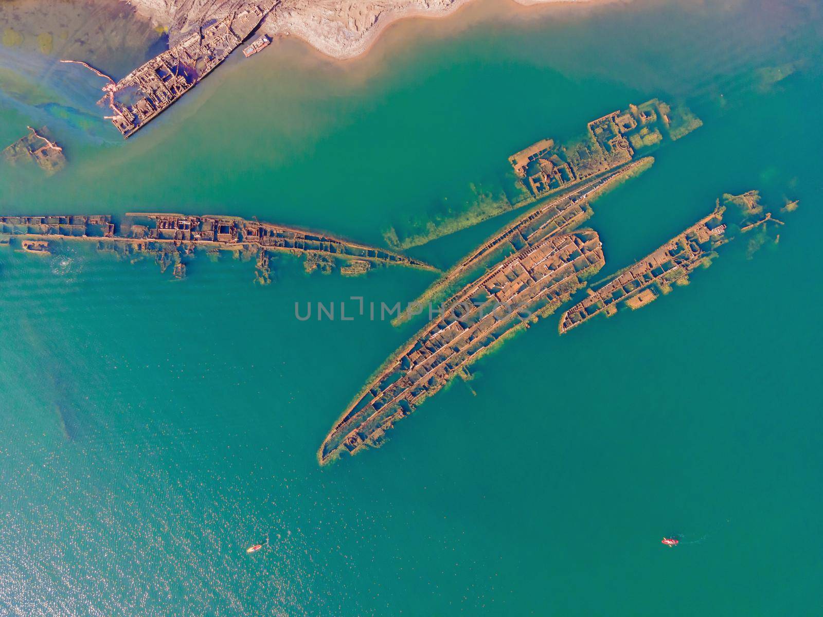 Abandoned broken shipwreck sticking out of the sea.