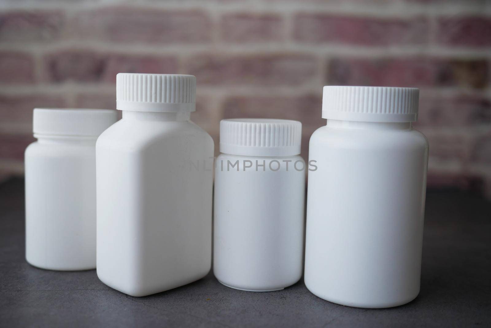 many pill container on wooden table ,