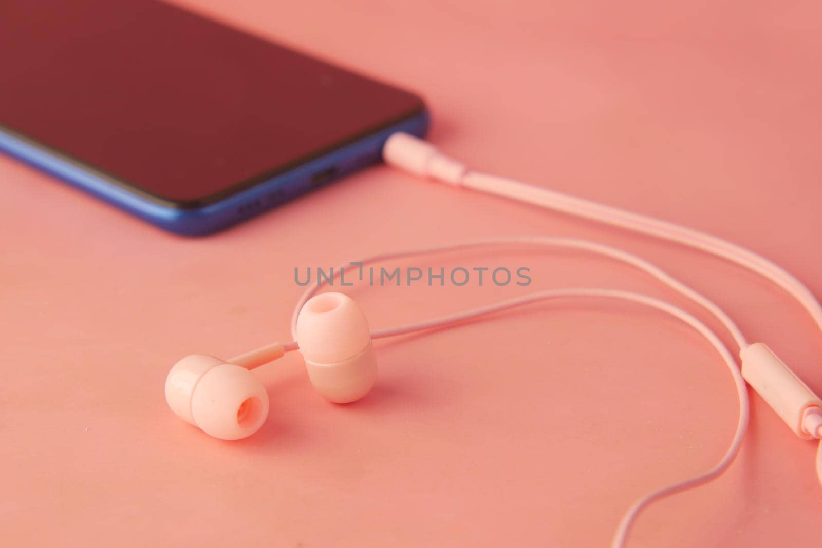 smart phone and headphone on wooden background