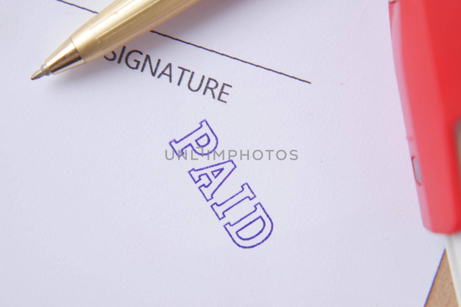 Paid invoice and Rubber Stamp on paper