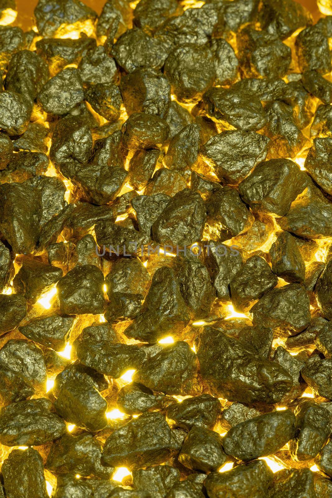 Gold nuggets as a background with golden light from below. by Fischeron