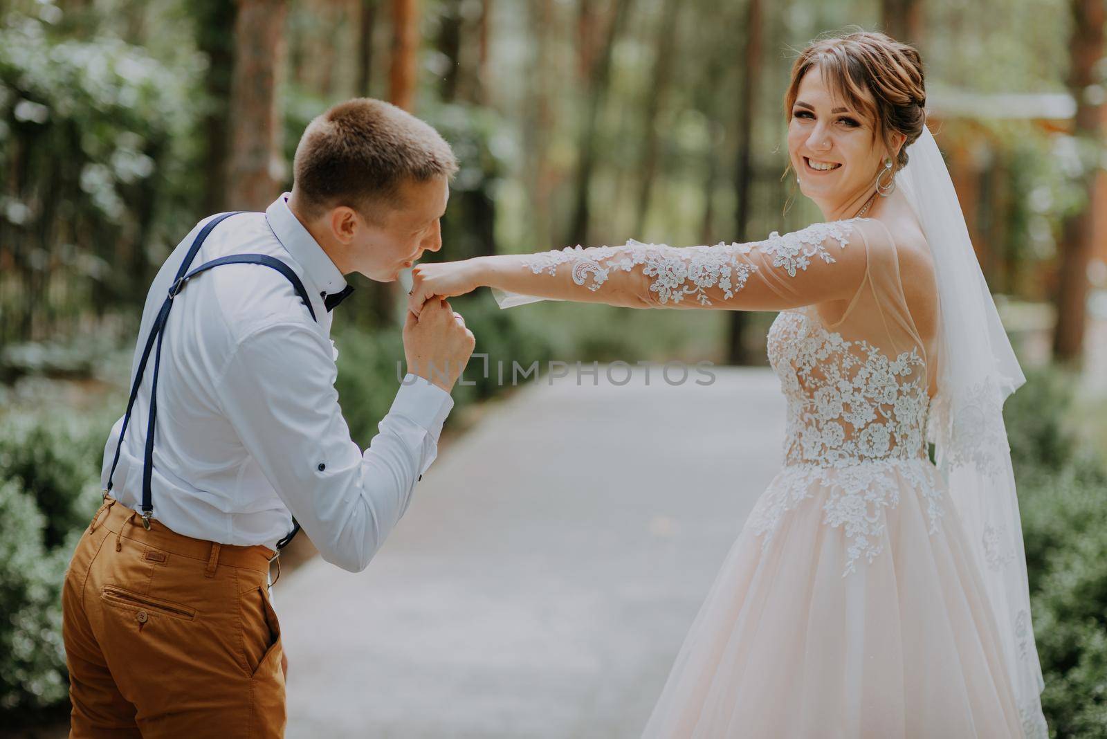 Sensual portrait of a young couple. Wedding photo outdoor. Wedding shot of bride and groom in park. Just married couple embraced