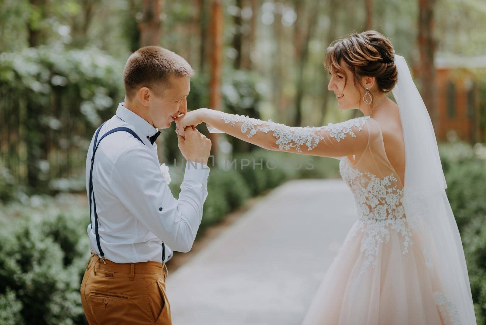 Sensual portrait of a young couple. Wedding photo outdoor. Wedding shot of bride and groom in park. Just married couple embraced. by Andrii_Ko