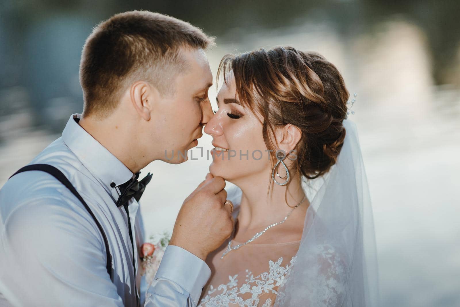 Sensual portrait of a young couple. Wedding photo outdoor. Wedding shot of bride and groom in park. Just married couple embraced