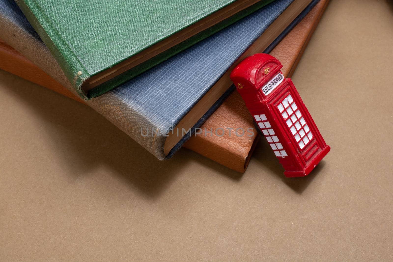 Classical British style Red phone booth beside books by berkay