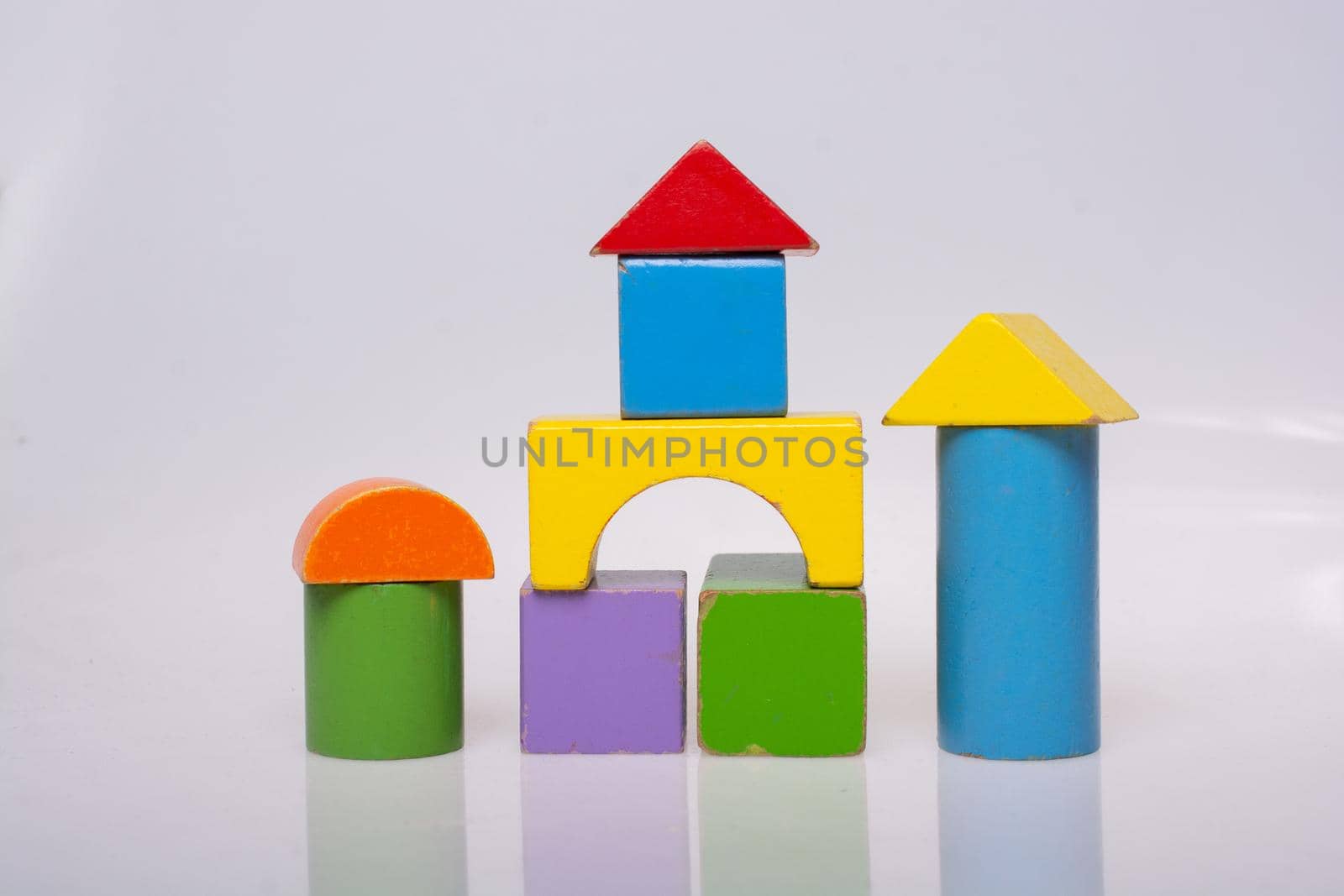 Building tower, castle  with Bright colorful wooden blocks toy
