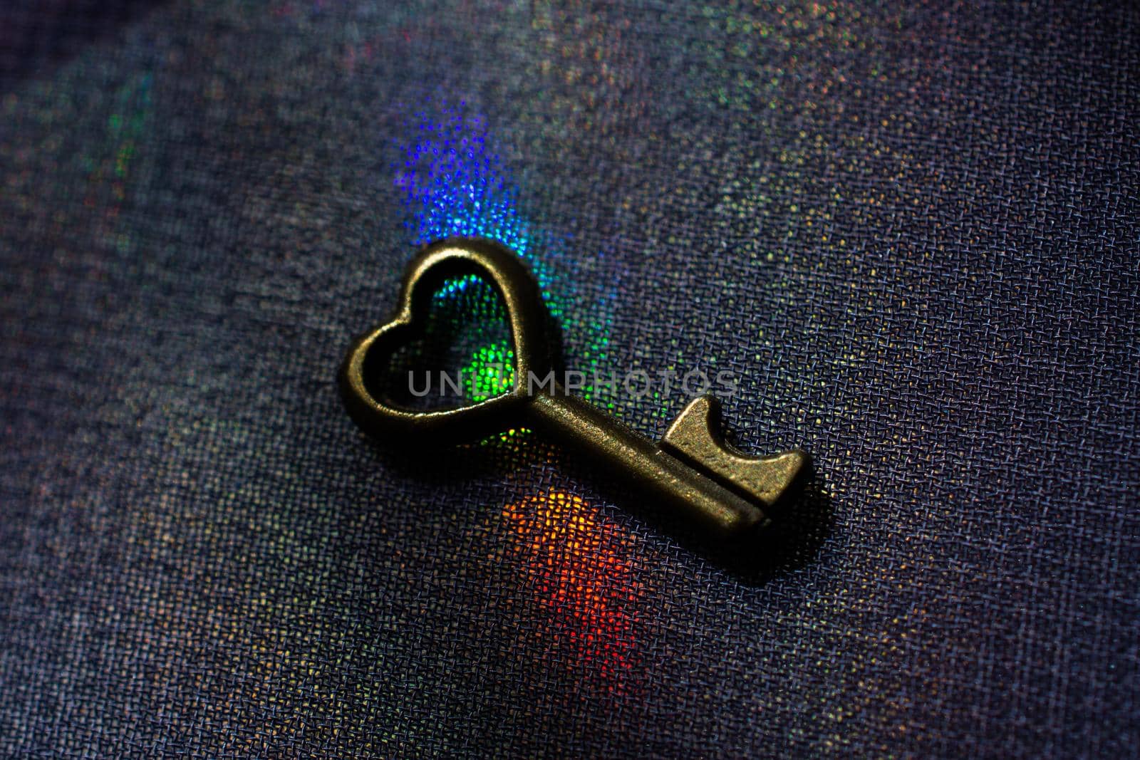 Vintage key. .Antique key. Retro key on colorful fabric background