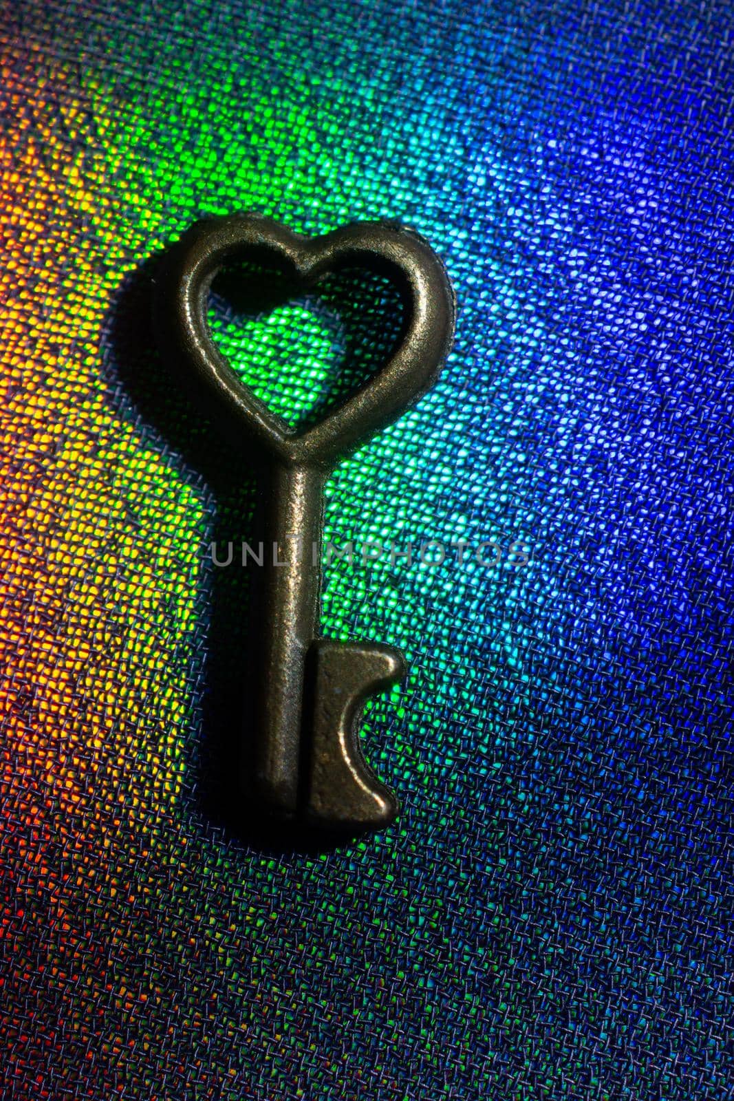 Vintage key. .Antique key. Retro key with a heart shape on  on colorful fabric  by berkay