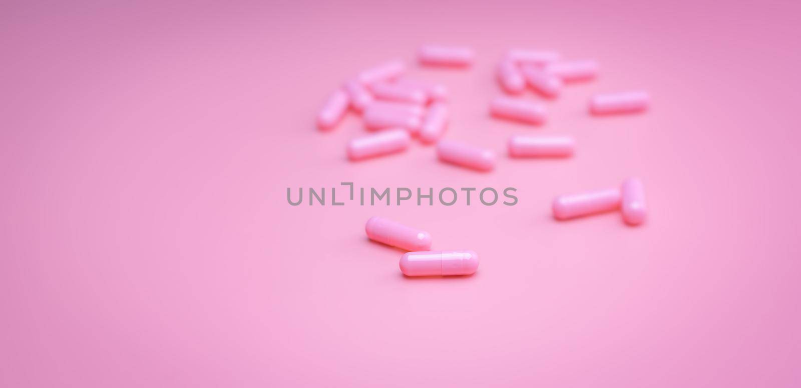 Pink capsules pill on pink background. Vitamins and supplements. Online pharmacy. Pharmacy store banner. Pharmaceutical industry. Woman's health insurance concept. Pills for love and happy life. by Fahroni