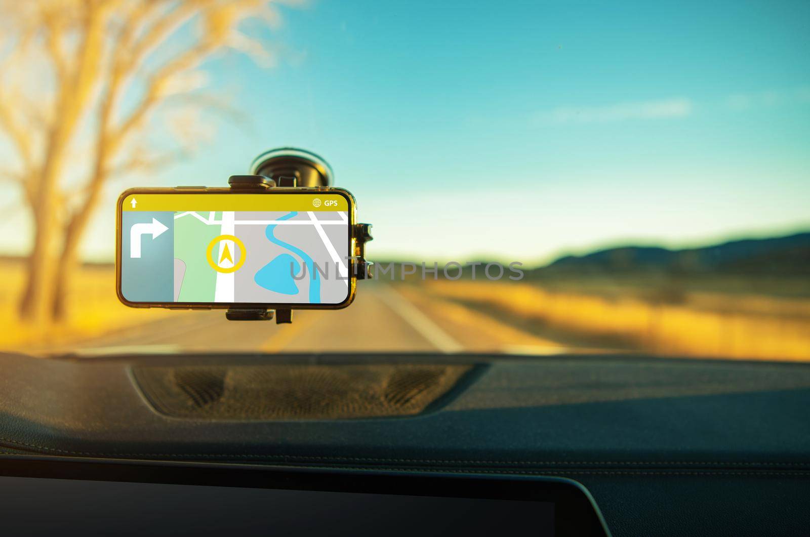 Smartphone Car Navigation Application. Device Attached to a Vehicle Windscreen. Road Traveling with a Map.