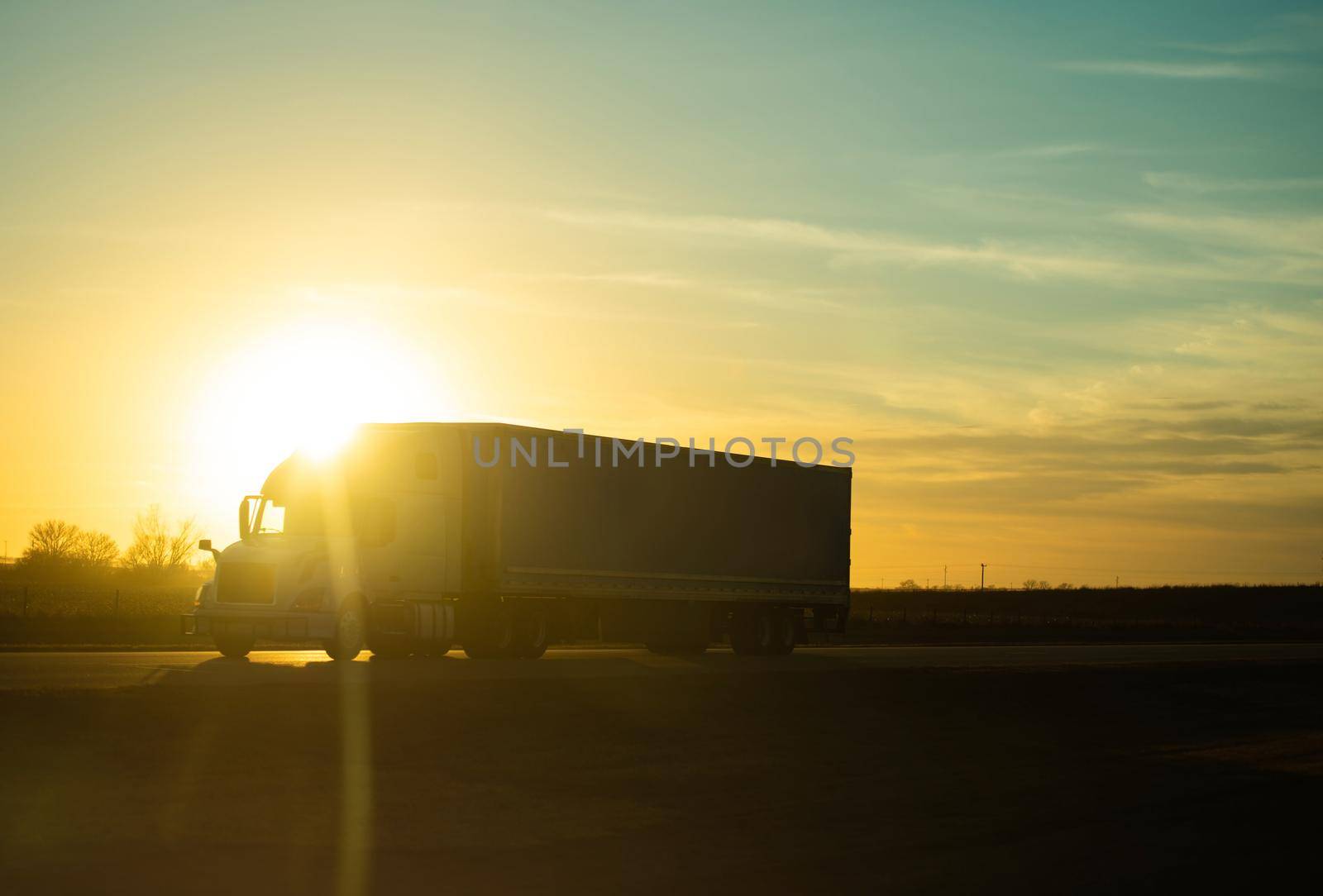 American Midwest Interstate Highway 80 Semi Truck Transportation Scenic Sunset. Freight Theme.