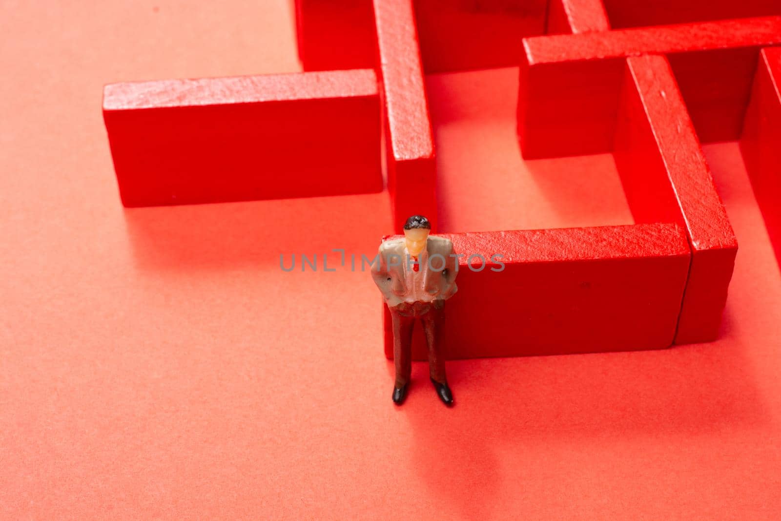 Man figurine and Red wooden labyrinth maze,  elevated high angle view by berkay