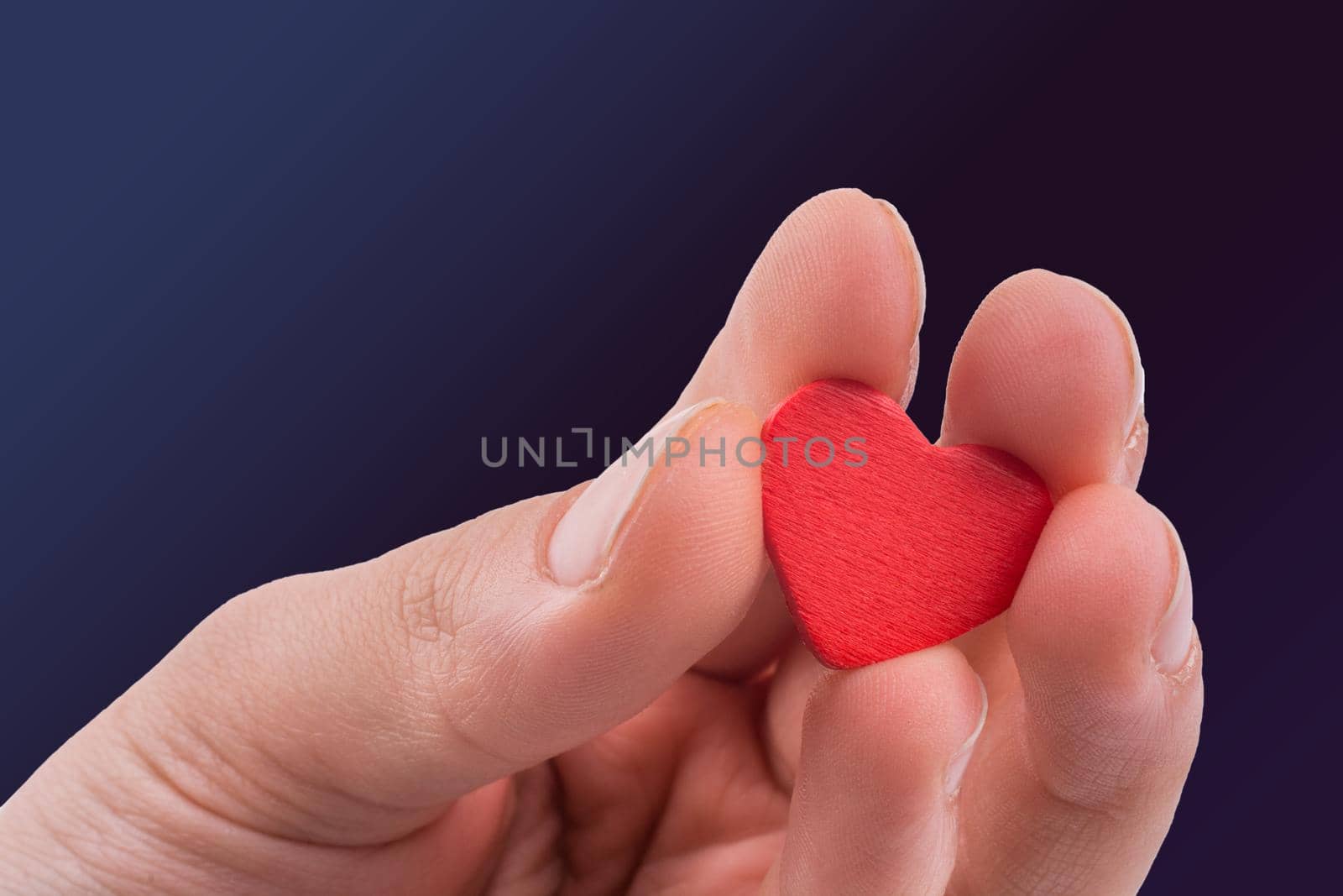 Hand with a red heart on a white background